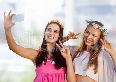 Women taking casual selfie photo in front of blurred background