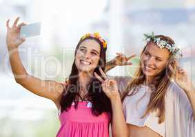 Women taking casual selfie photo in front of blurred background