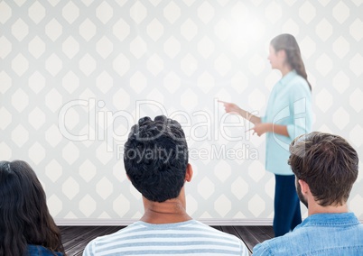 Group of people sitting in front of bright background with speaker