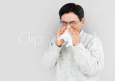 Portrait of Man blowing his nose with grey background