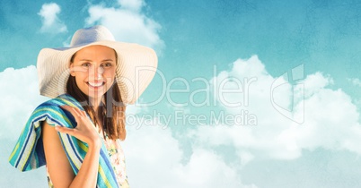 Woman in sun hat with towel against Summer sky