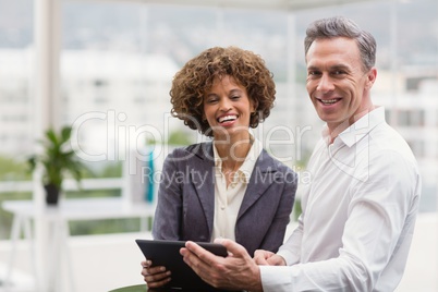 Happy business people holding a tablet