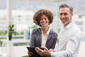 Happy business people holding a tablet