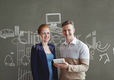 Happy business people holding a tablet against grey background with graphics