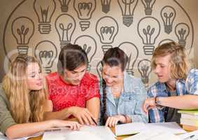 Group of students studying in front of light bulbs graphics