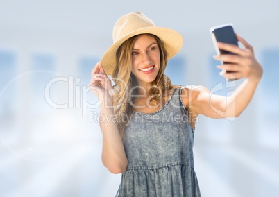 Woman taking casual selfie photo in front of blurred background