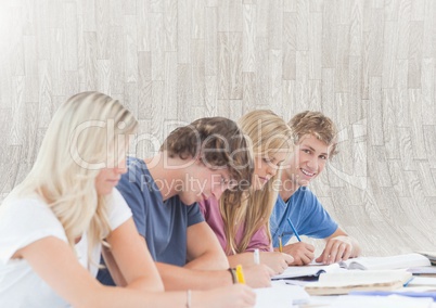 Group of students sitting in front of bright background