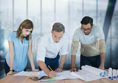 Business people at a desk looking at a paper
