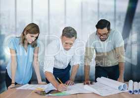 Business people at a desk looking at a paper