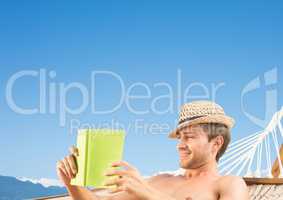 Man reading in hamoc against Summer sky