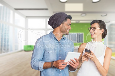 Happy business people holding a tablet and a phone