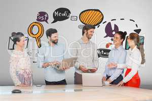 Happy business people at a desk using computers and tablets against white background with graphics