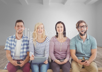 Group of people sitting with devices in front of room