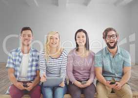 Group of people sitting with devices in front of room