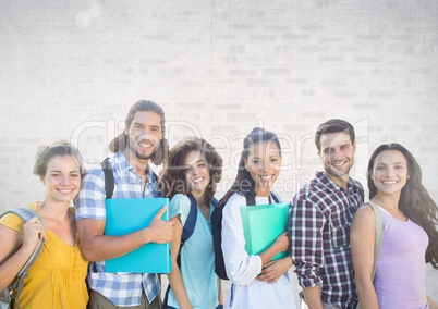 Group of students standing in front of brick grey background