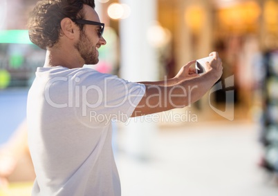 Man taking casual selfie photo in front of Shopping Mall