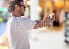 Man taking casual selfie photo in front of Shopping Mall