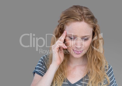 Portrait of red haired stressed woman with grey background