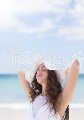 Woman at the beach closing her eyes