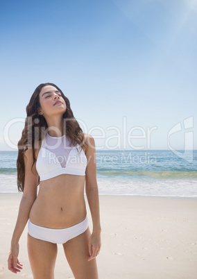 Woman at the beach standing in the sand