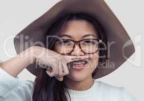 Portrait of woman being silly with grey background