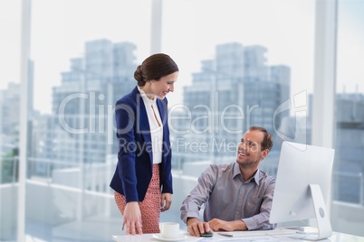 Business people at a desk smiling