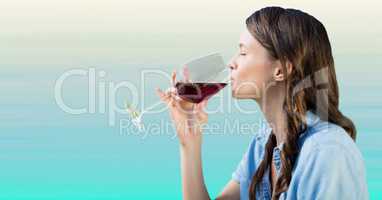Woman tasting wine against light blue background