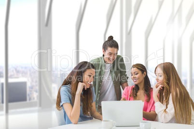 Happy business people at a desk looking at a computer