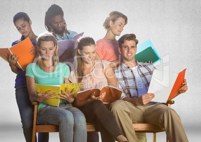 Group of students studying sitting in front of blank grey background