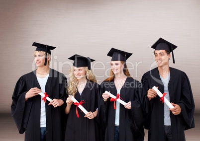 Group of graduates standing in front of blank brown background