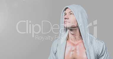 Portrait of muscular strong Man in hoodie with grey background