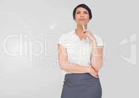 Portrait of businesswoman holding pen with grey background