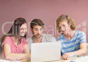 Group of friends with laptop sitting in front of blank rose background