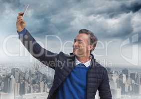 Man taking casual selfie photo in front of city skyline