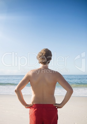 Man at the beach standing in the sun