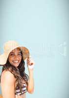 Millennial woman sun hat and bikini against light blue background