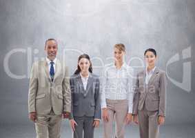 Group of business people standing in front of blank grey background