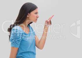 Portrait of woman pointing with grey background