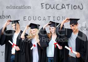Group of graduates standing in front of education text
