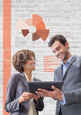 Happy business people using a tablet against white wall with graphics