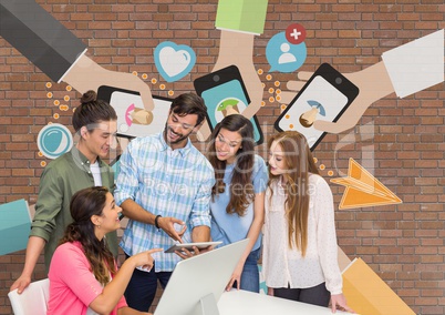 Happy business people at a desk looking at a computer against brick wall with graphics