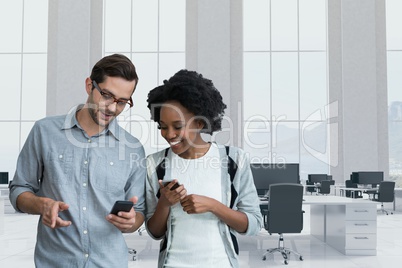 Happy business people looking at a phone