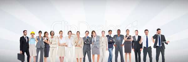 Group of business people standing in front of bright grey background