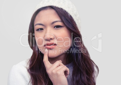 Portrait of woman deciding with grey background