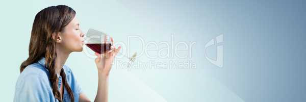 Woman tasting wine against blue background