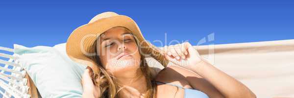 Close up of millennial woman on hamoc against Summer sky