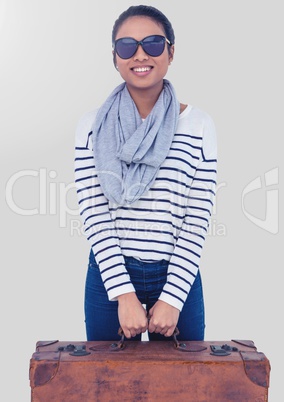 Portrait of woman holding briefcase and sunglasses with grey background