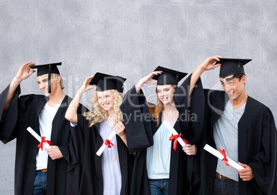 Group of graduates standing in front of blank grey background