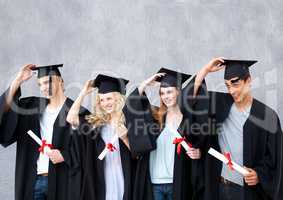 Group of graduates standing in front of blank grey background