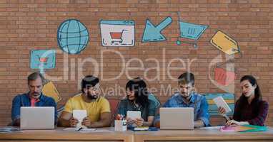 Business people at a desk looking at computers and tablets against brick wall with graphics